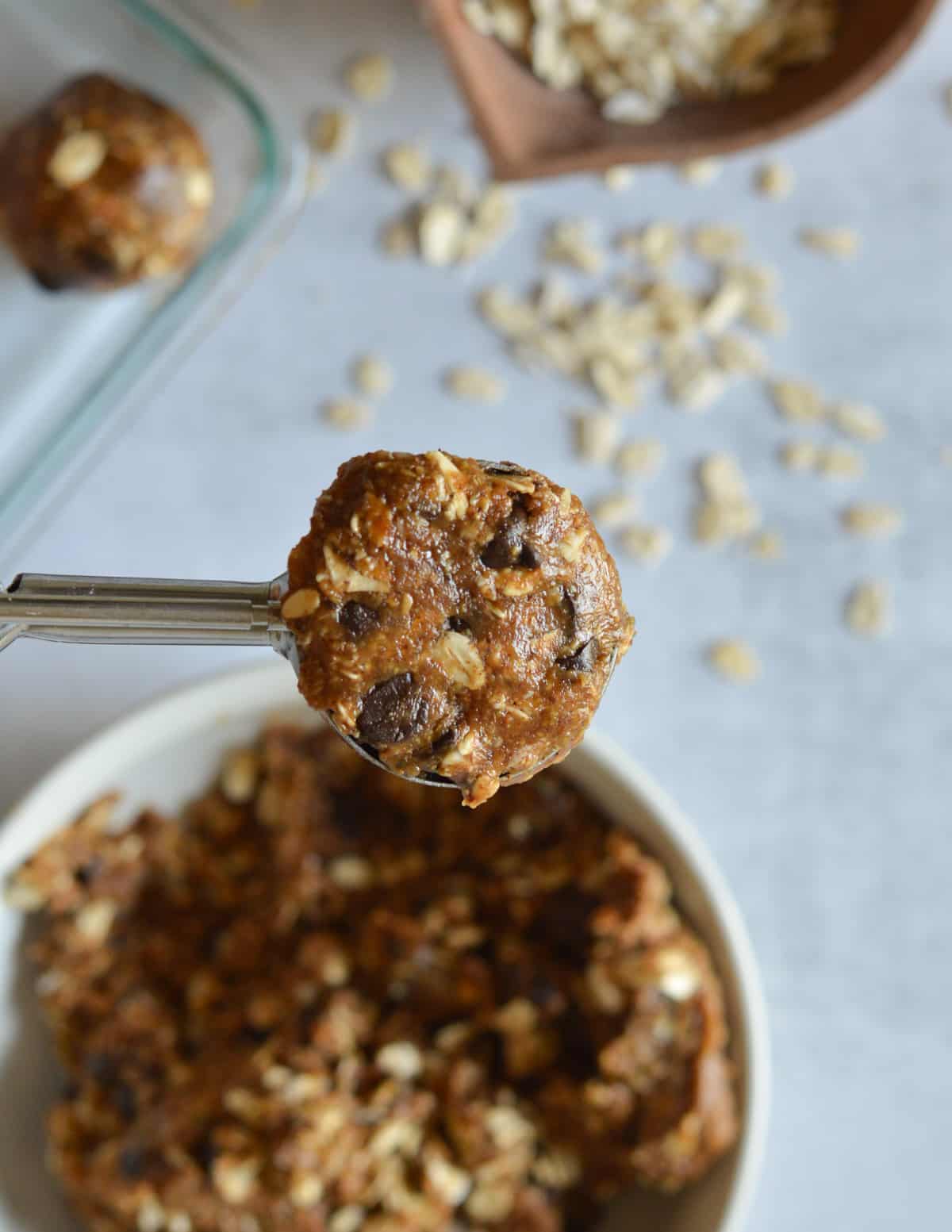 an almond butter energy ball in a portion scoop.