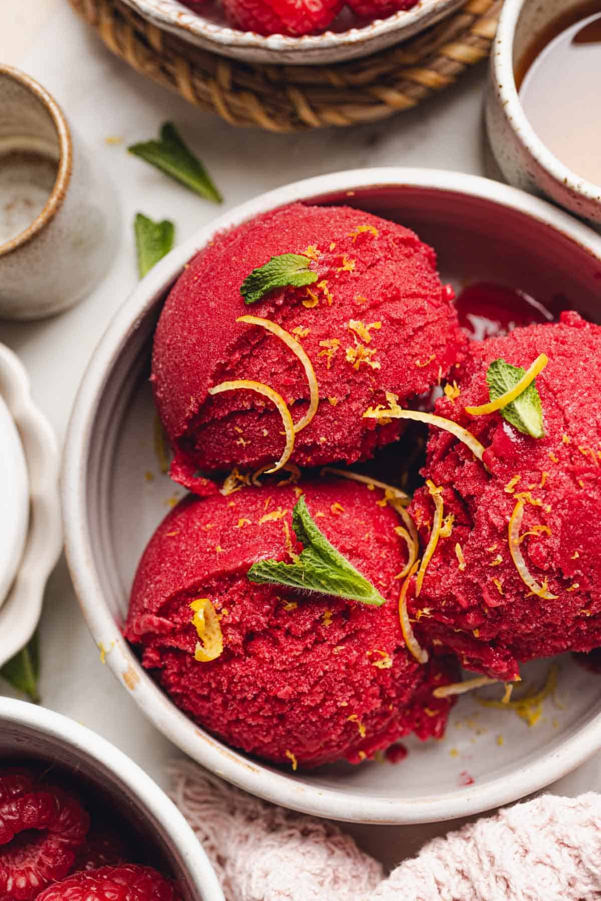 a bowl with three scoops of raspberry sorbet in it.