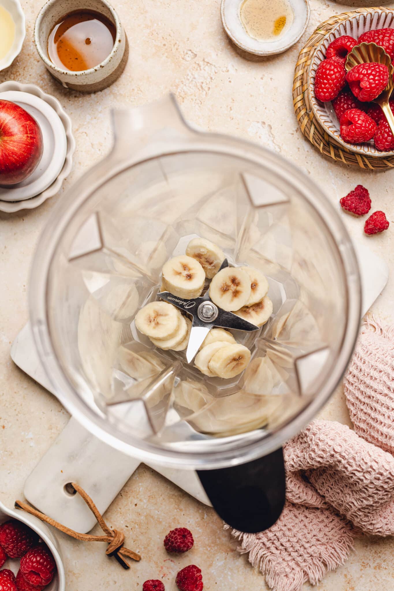 a blender with frozen sliced bananas in it.