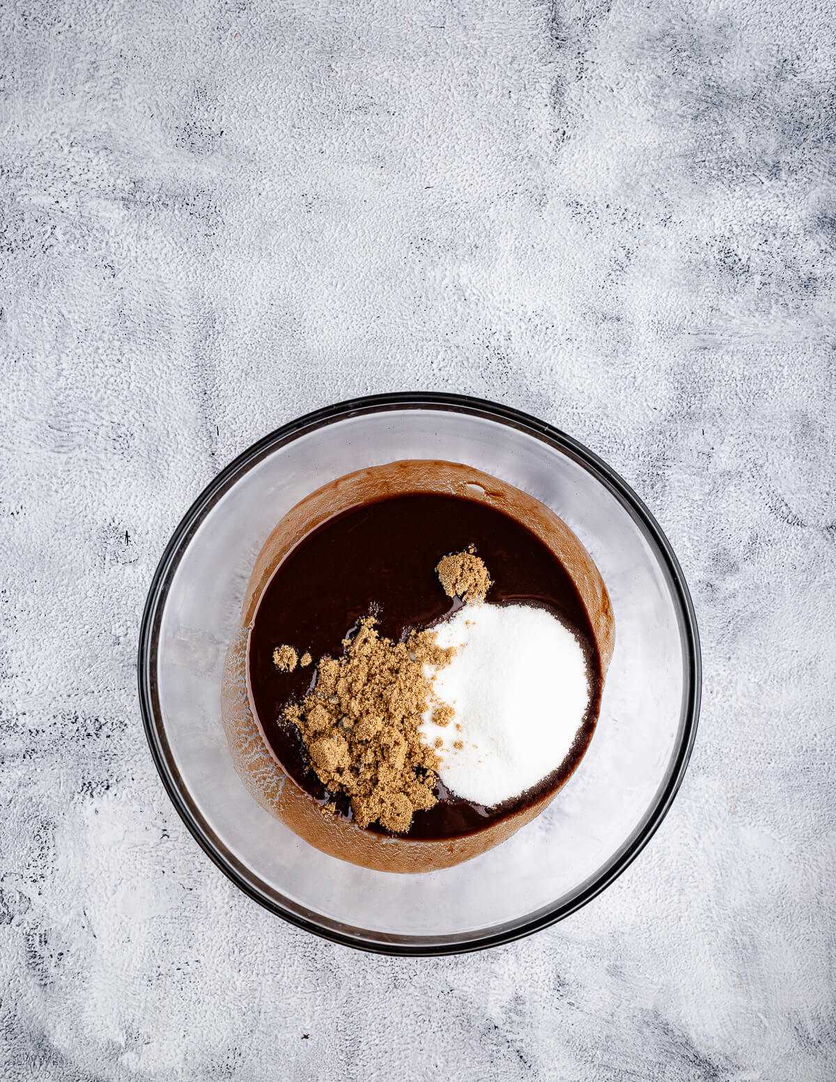 melted chocolate, brown sugar, and sugar in a bowl.