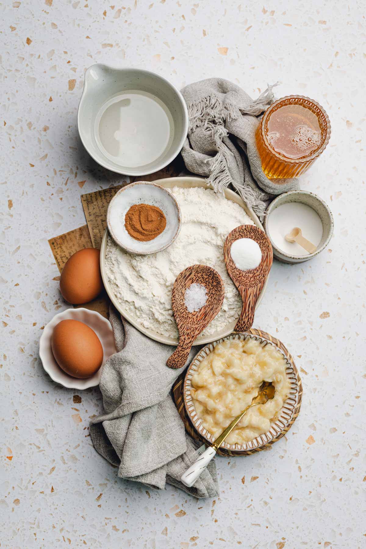 coconut oil, honey, cinnamon, flour, baking powder, baking soda, salt, and mashed banana.