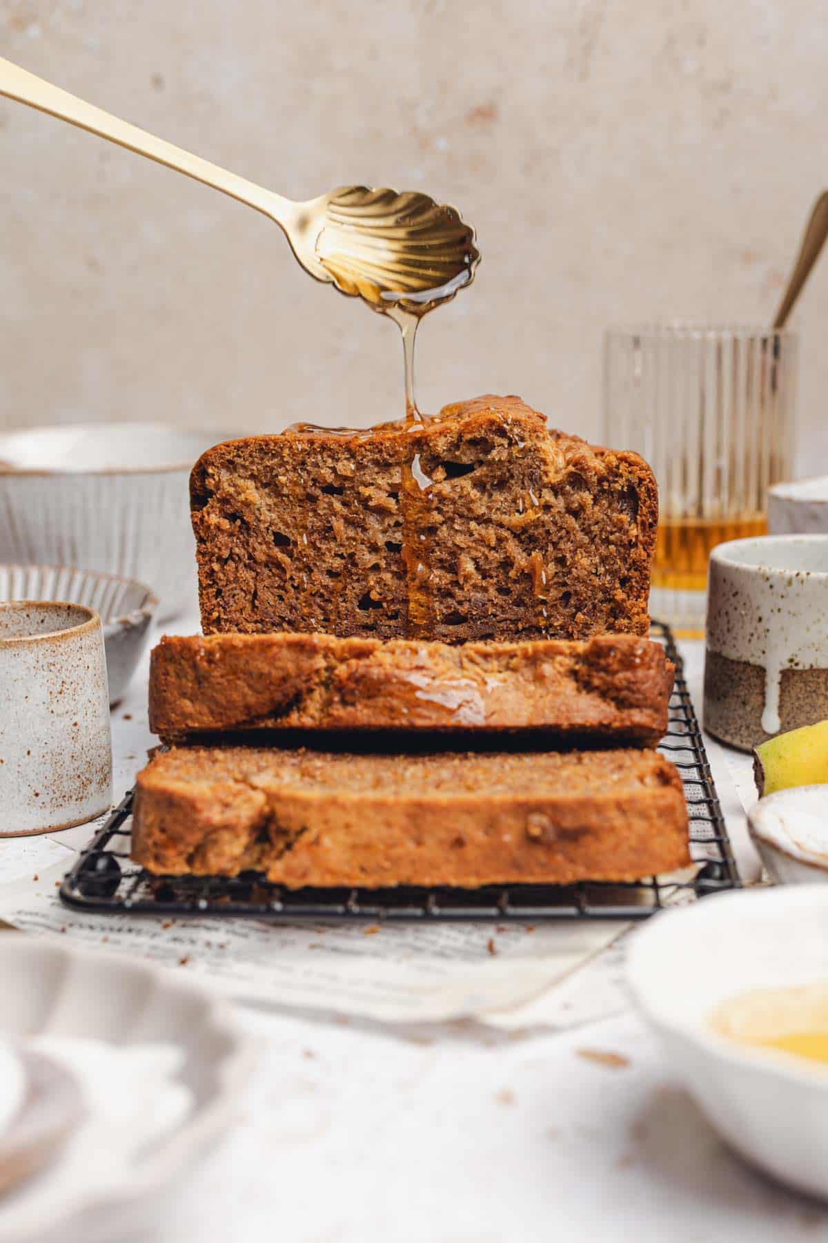 drizzling honey on sliced banana bread.