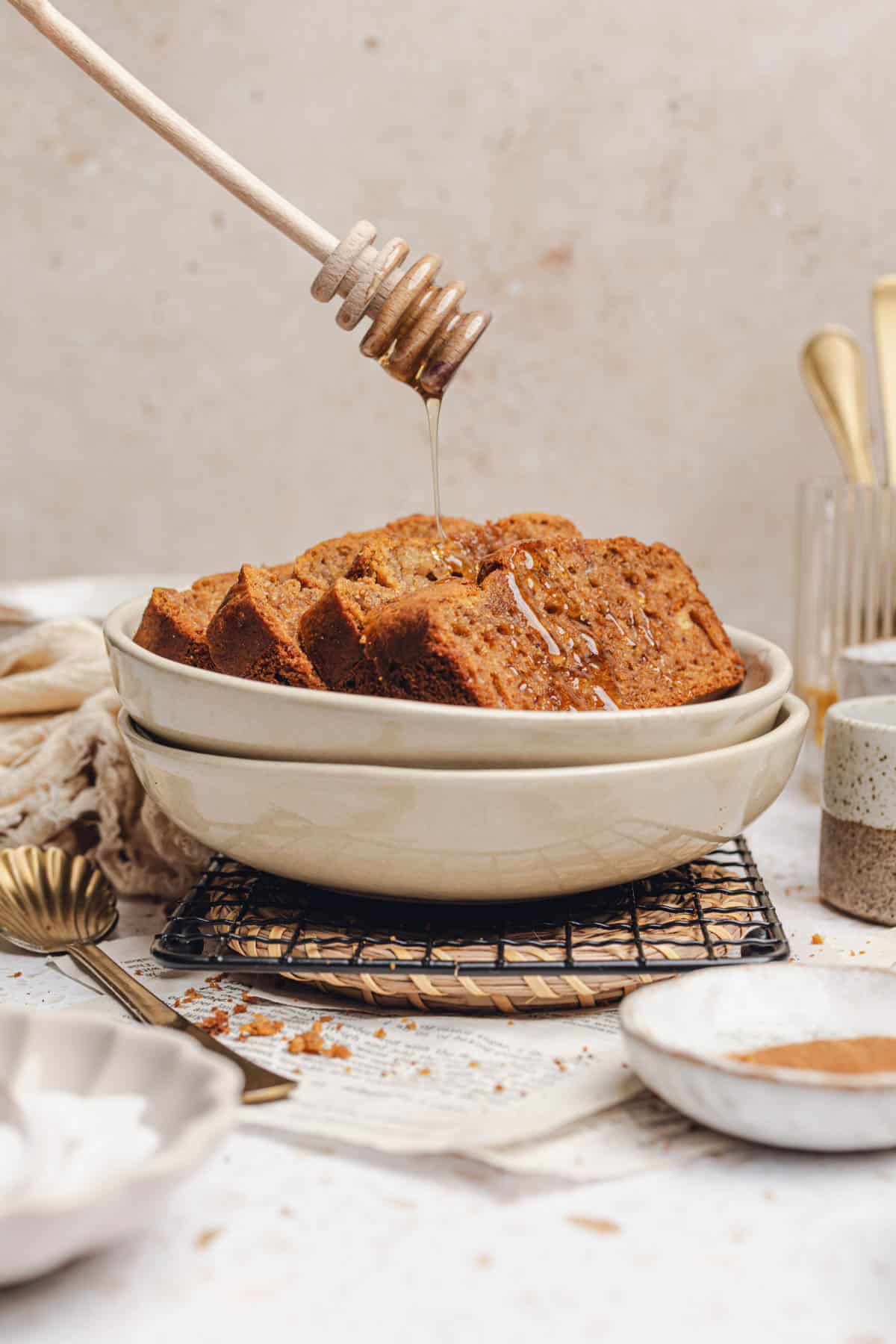 a bowl with slices of banana bread in it with honey drizzled on top