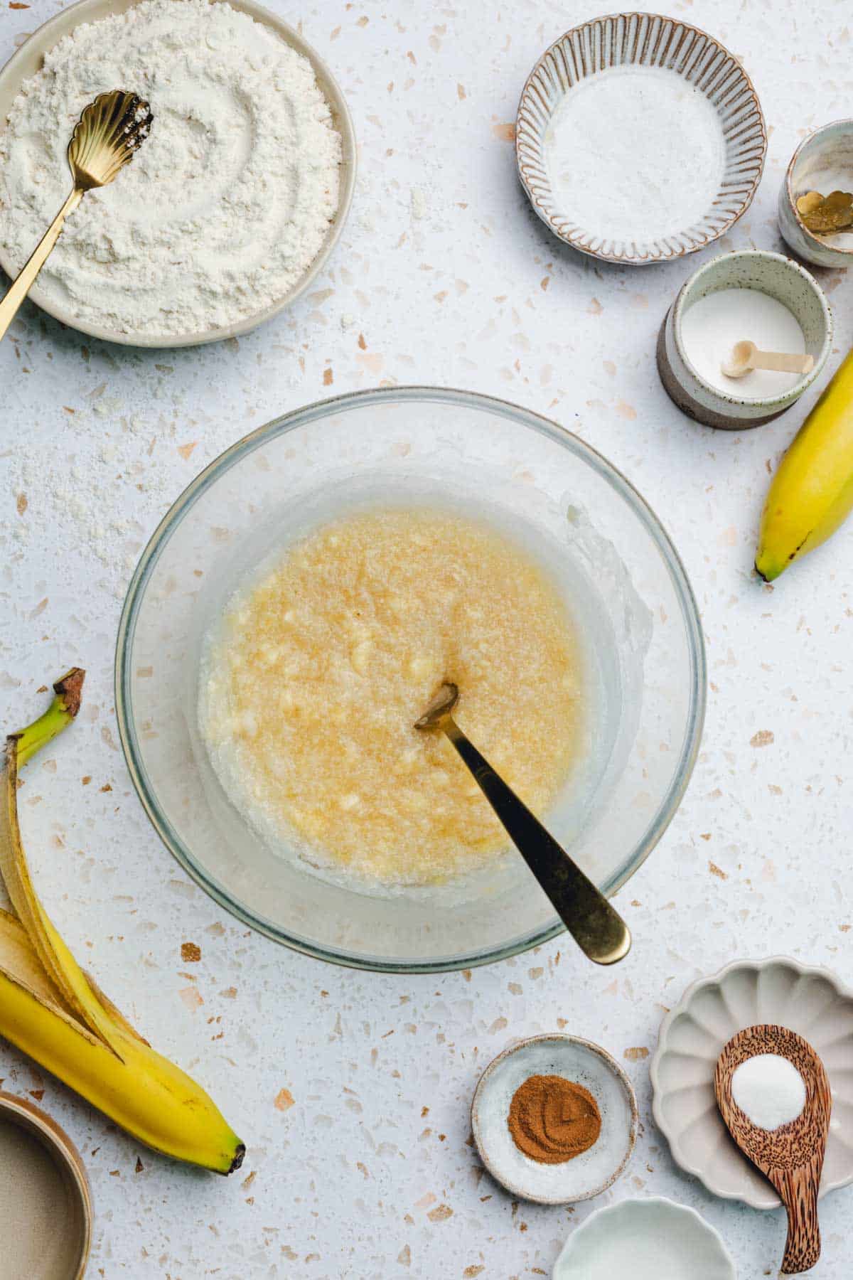 a bowl of mixed banana, oil, and honey.