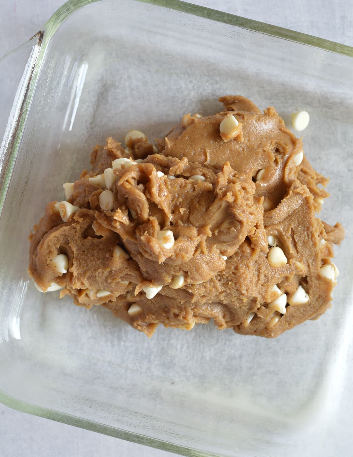 gluten-free blondie dough in a glass baking dish.