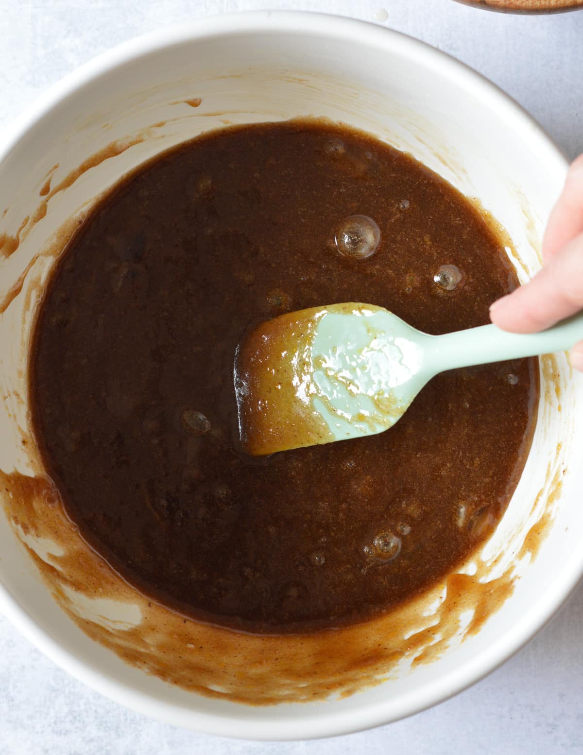 a bowl with browned butter, eggs, and brown sugar mixed together.