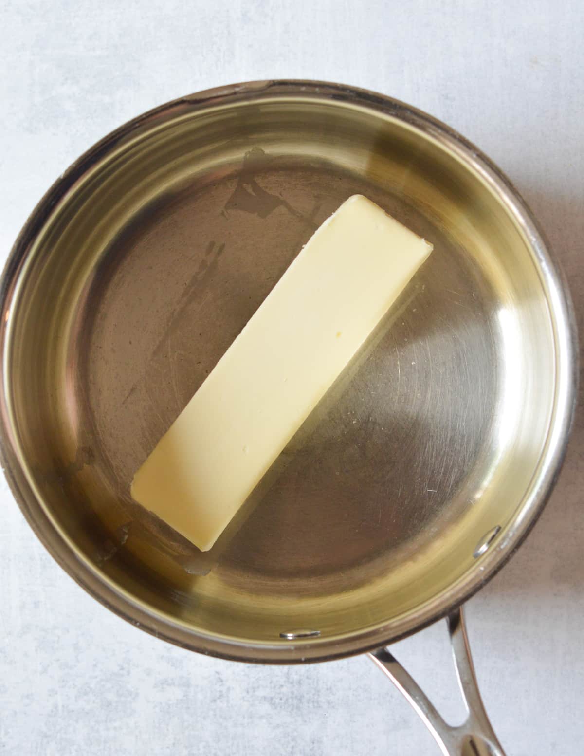 a stick of butter in a saucepan.