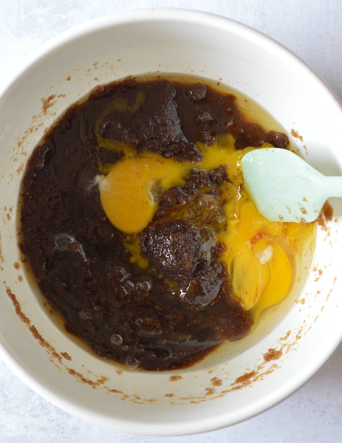 a bowl of browned butter and brown sugar mixed together with eggs on top.