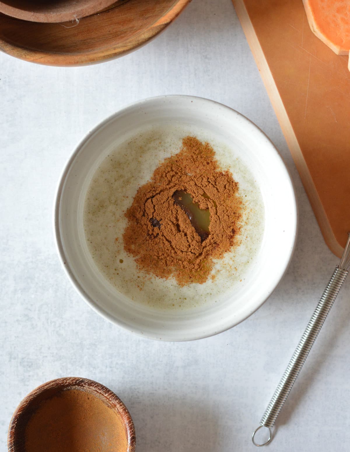 melted butter, cinnamon, and maple syrup in a bowl.