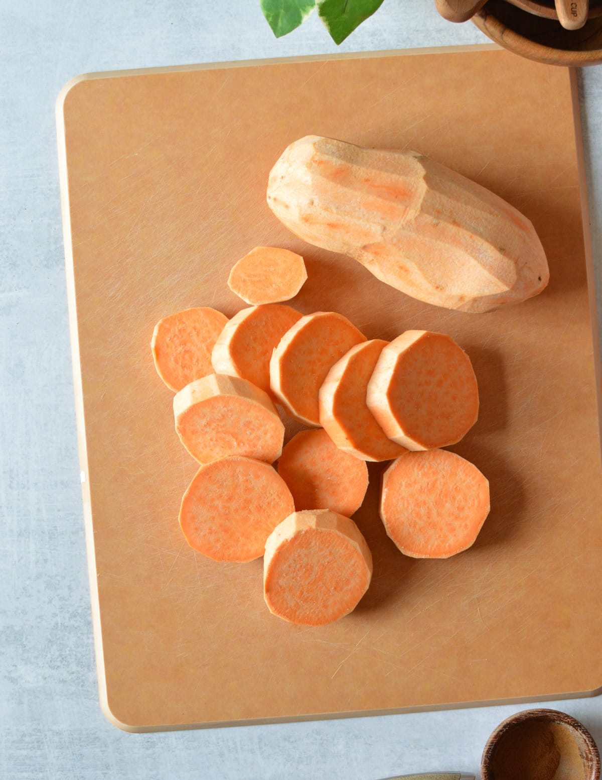 sliced sweet potatoes on a cutting board.