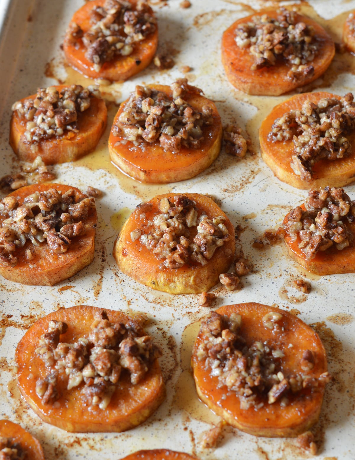 roasted sweet potato slices with candied pecans on top.