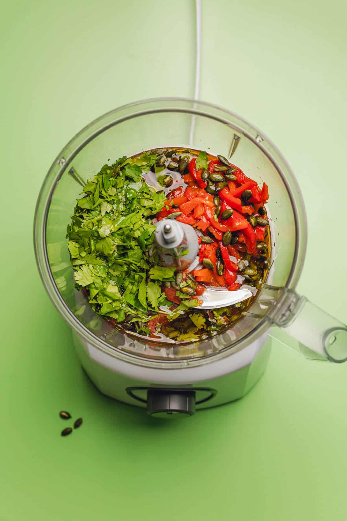 cilantro, roasted red peppers, tomatoes, pepitas, olive oil, and red wine vinegar in a food processor.