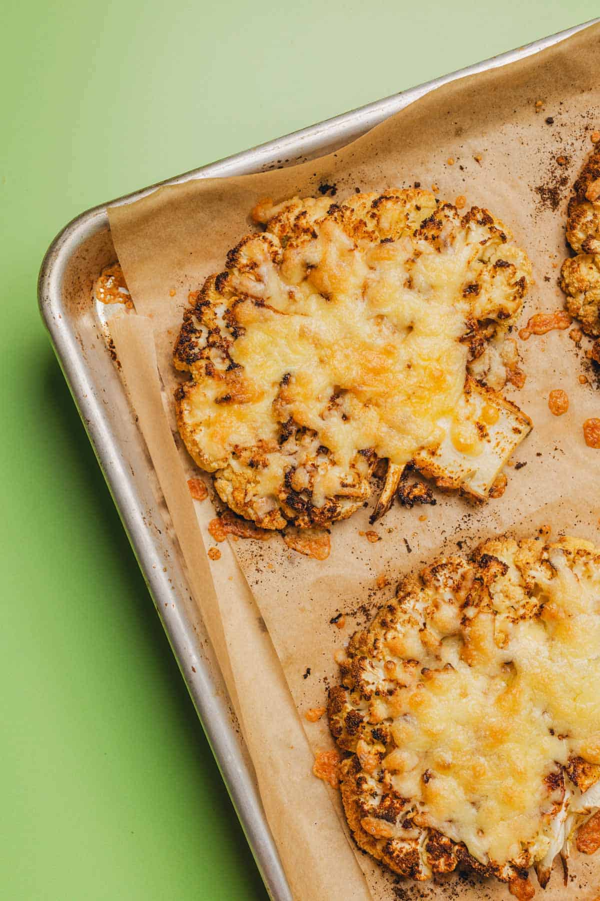roasted cauliflower steaks with melted gouda cheese on top.