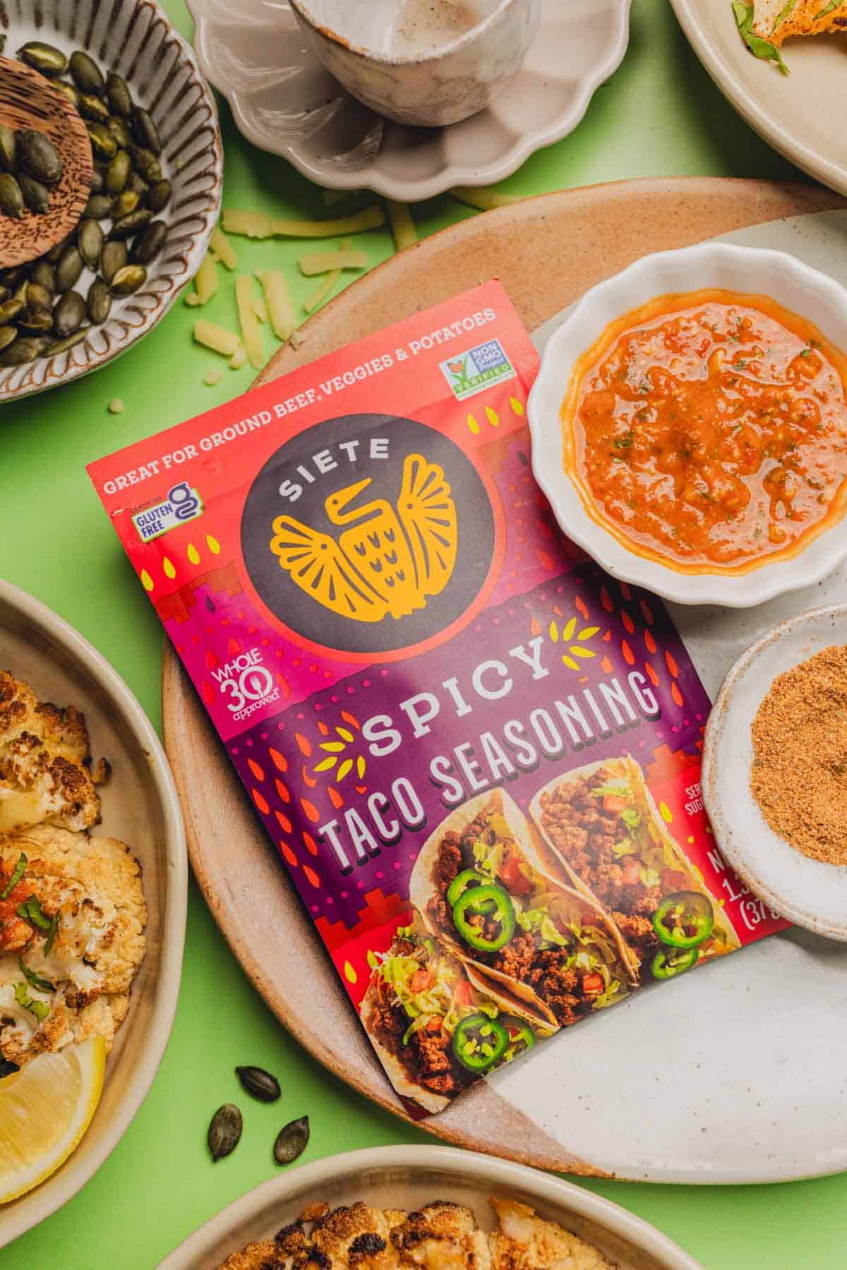 siete taco seasoning on a plate near salsa and roasted cauliflower.