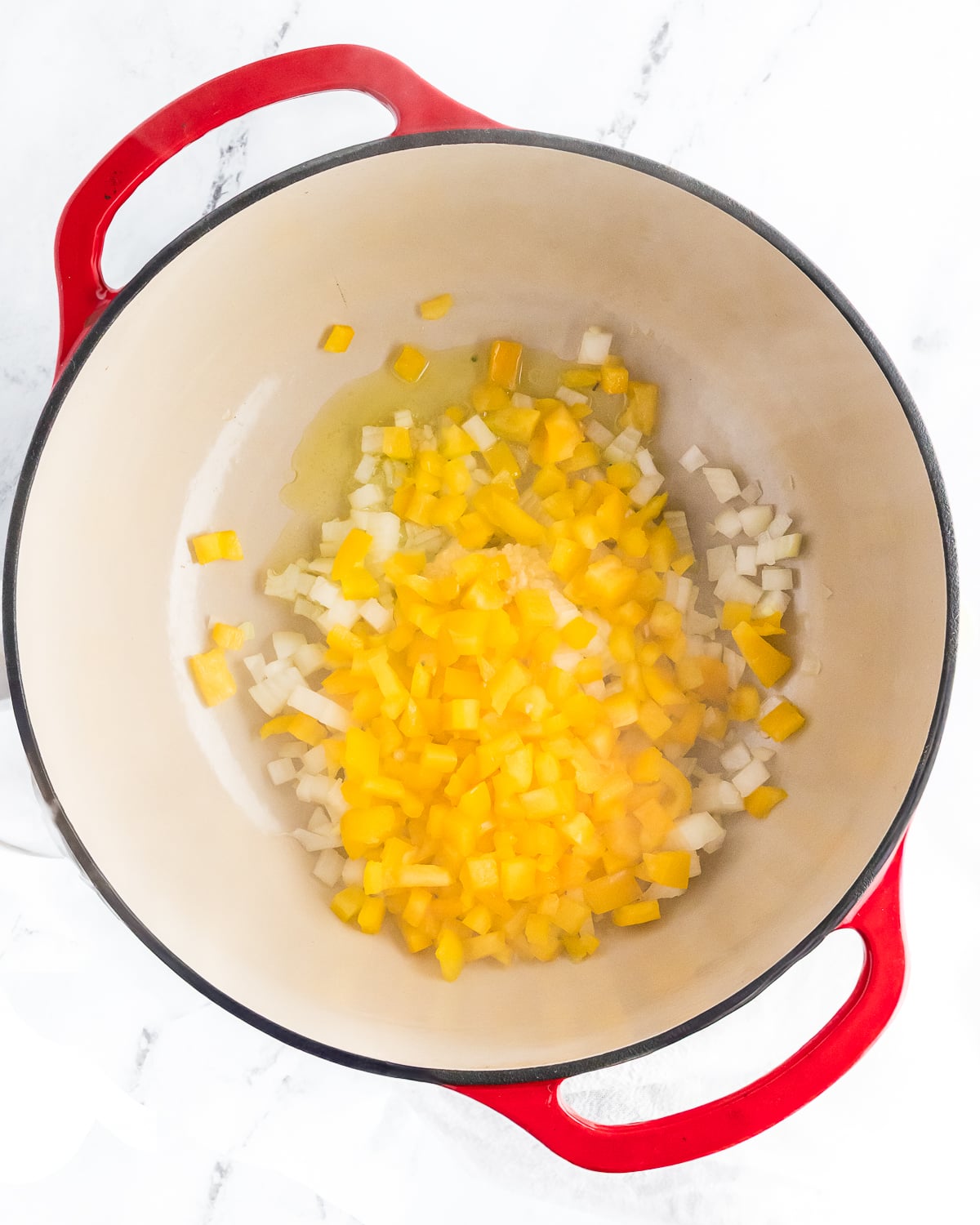 yellow bell pepper, onion, and olive oil in a dutch oven.