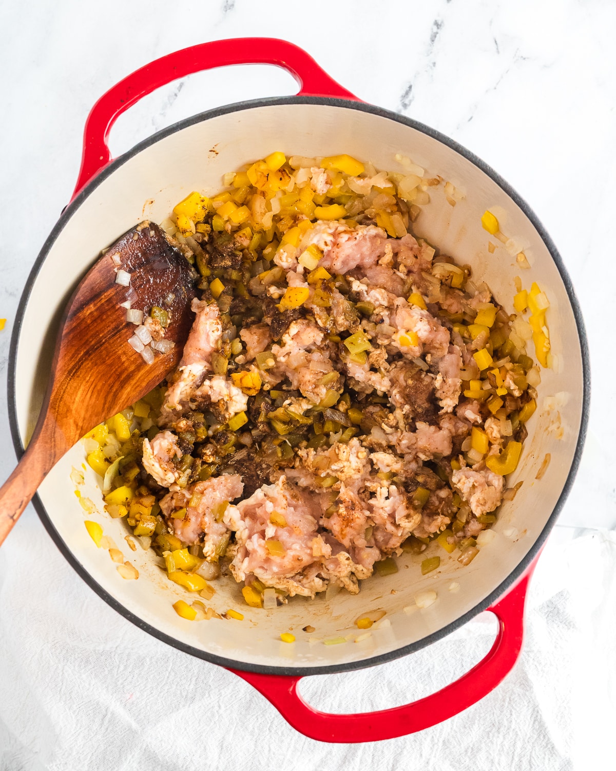 sauteed bell pepper, onion, ground chicken, and green chiles in a pot.