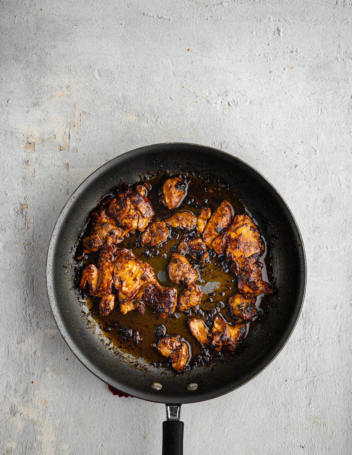 caramelized chipotle honey chicken thighs in a skillet.