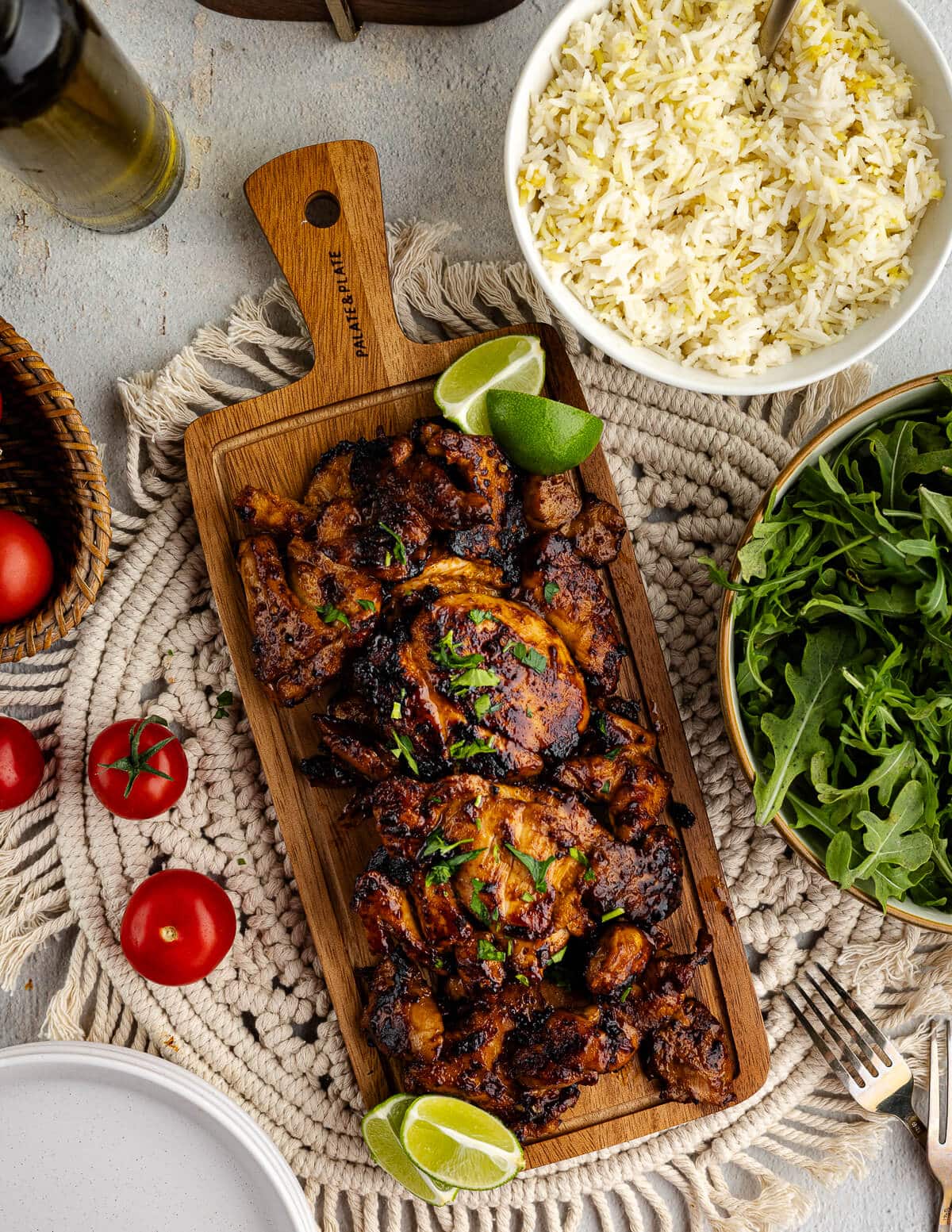 honey chipotle chicken thighs on a cutting board with limes.