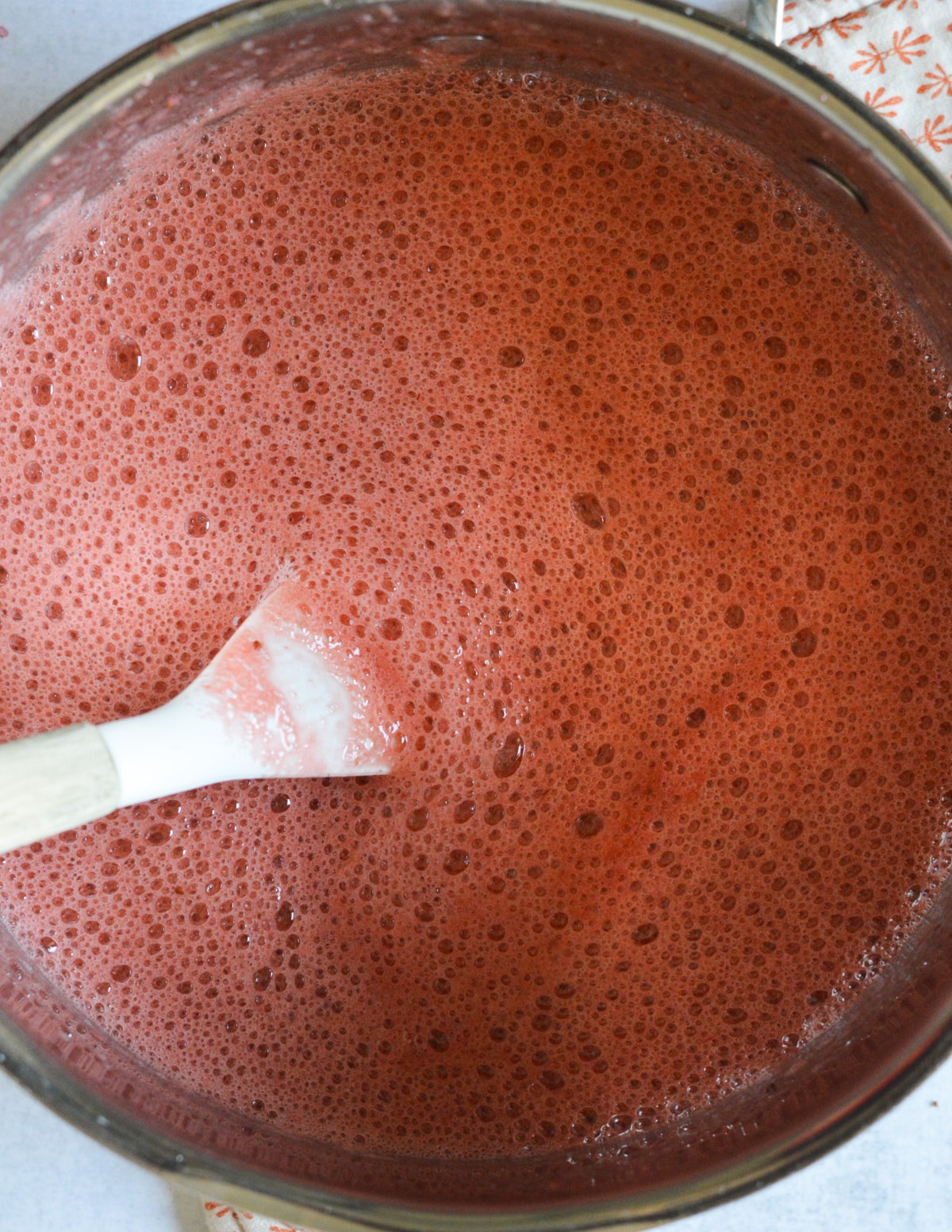 blended strawberry mixture in a saucepan.