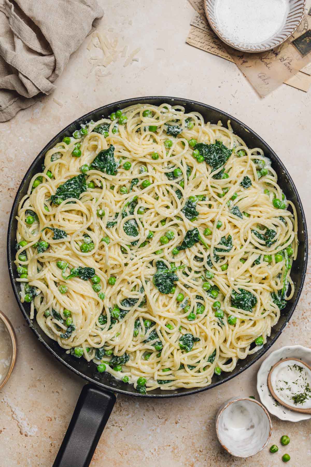 a skillet with lemon ricotta pasta in it.