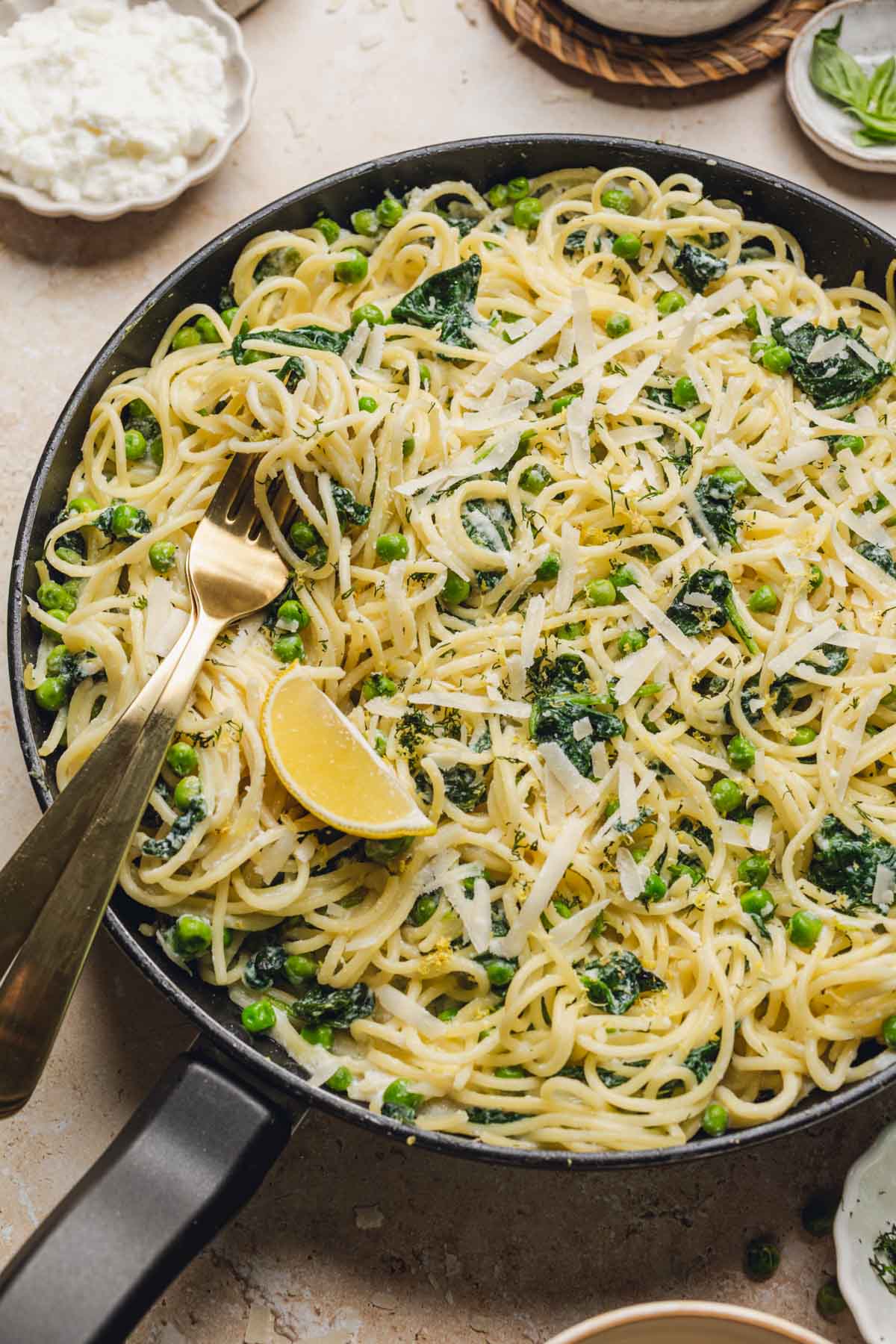 a skillet with lemon ricotta pasta in it