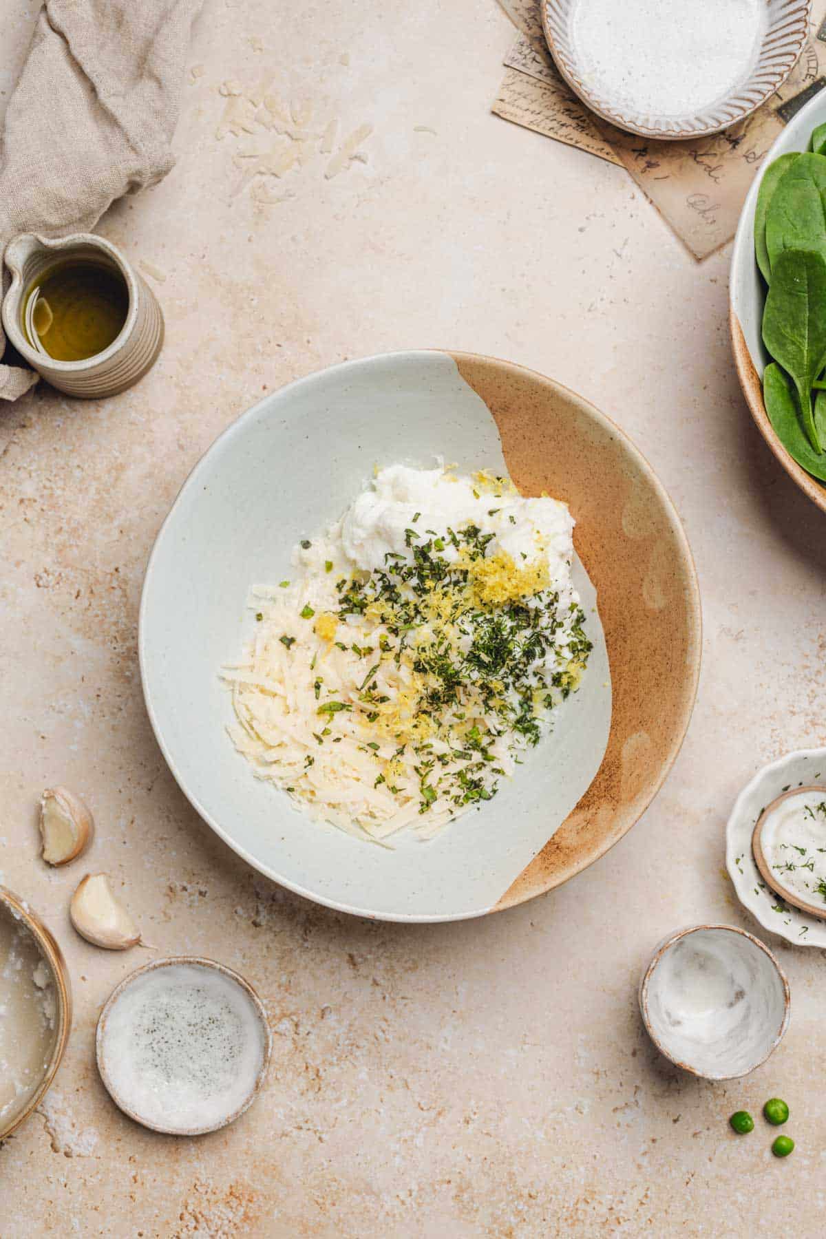 a bowl of parmesan, basil, dill, lemon zest, and ricotta.