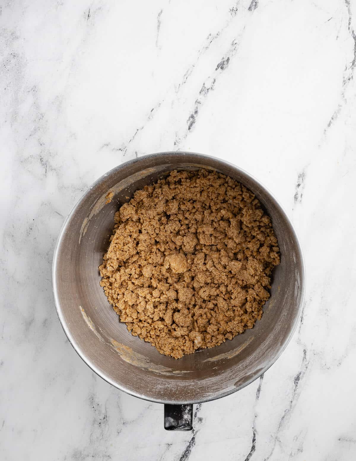 a mixing bowl with graham cracker cookie dough crumbles in it.