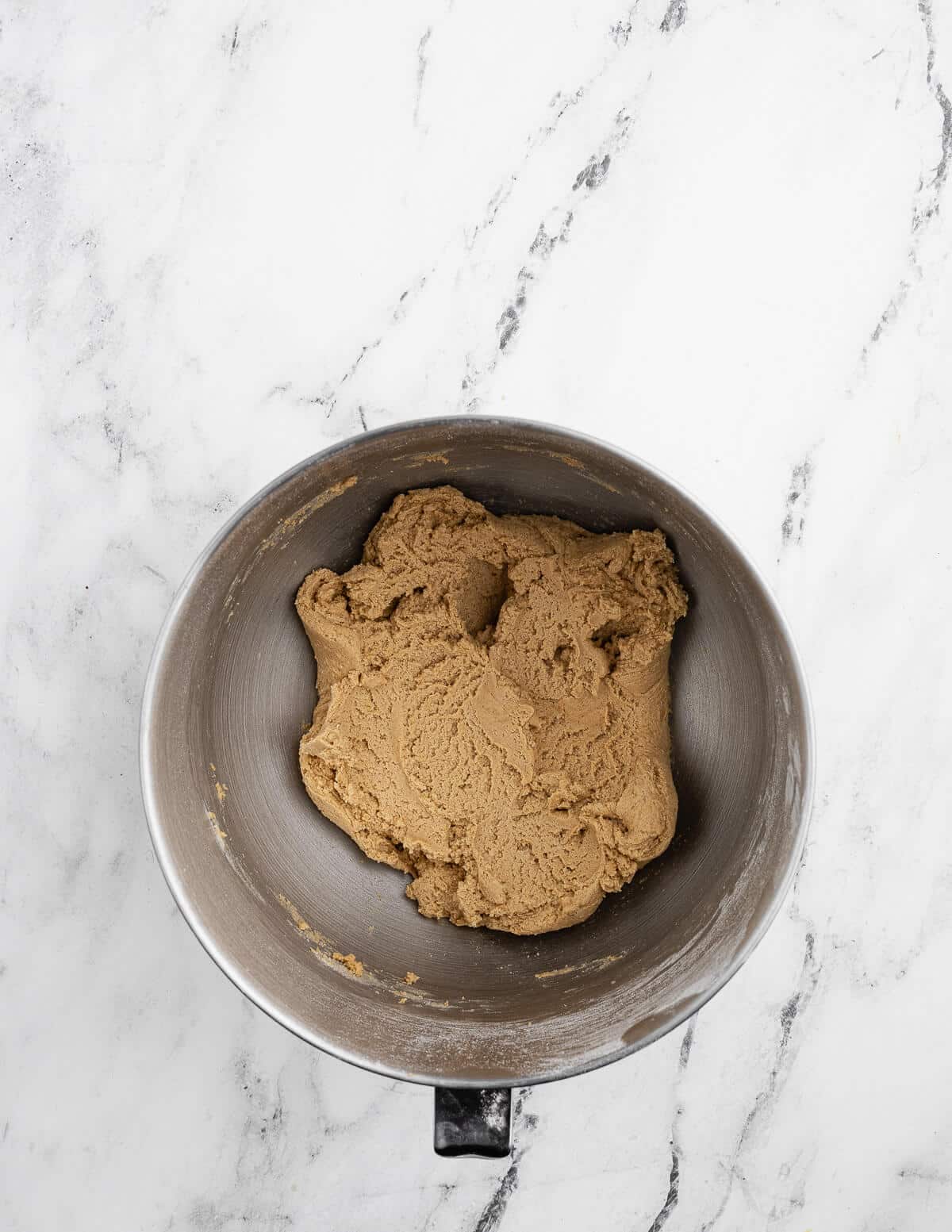 a mixing bowl with gluten free graham cracker cookie dough in it.