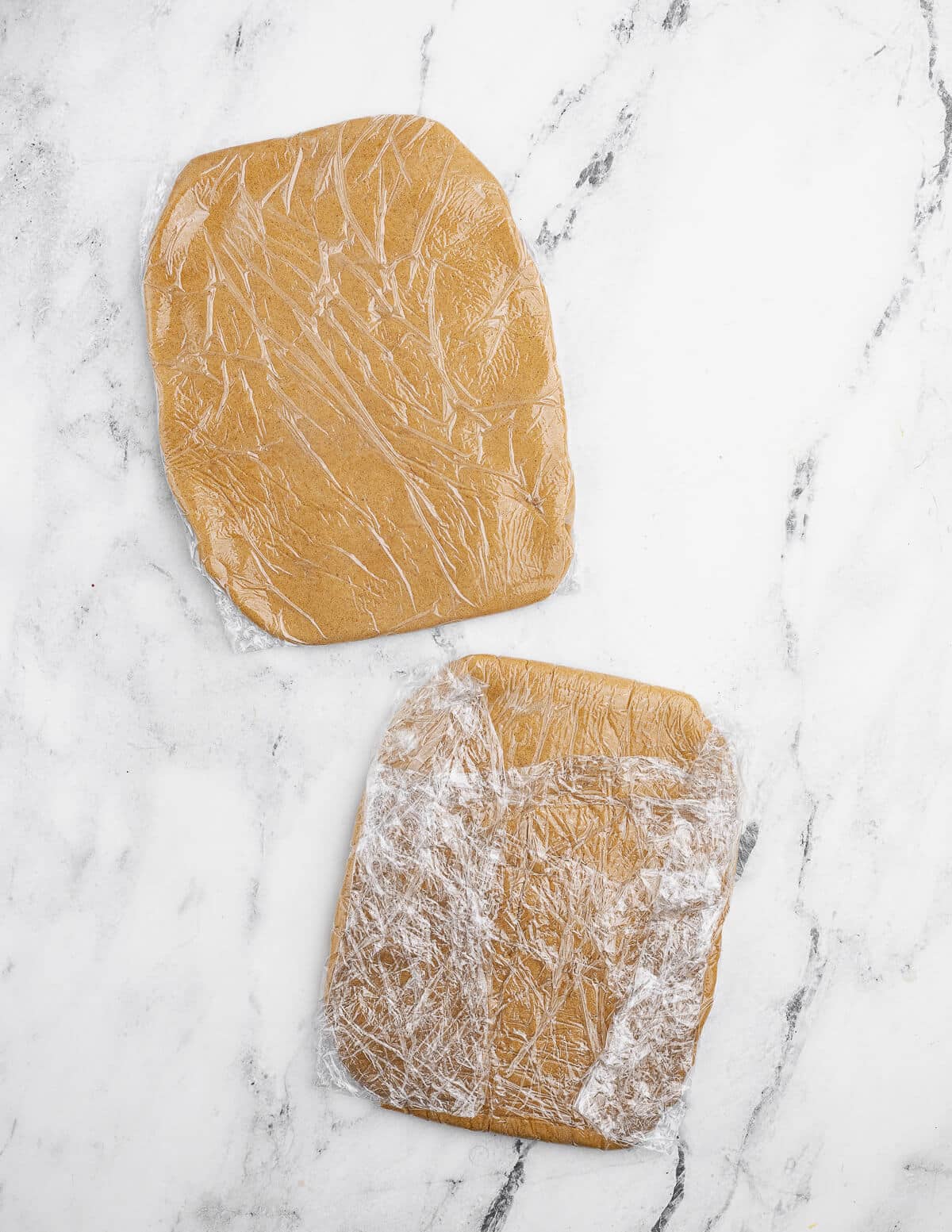 two saran wrapped cookie dough rectangles