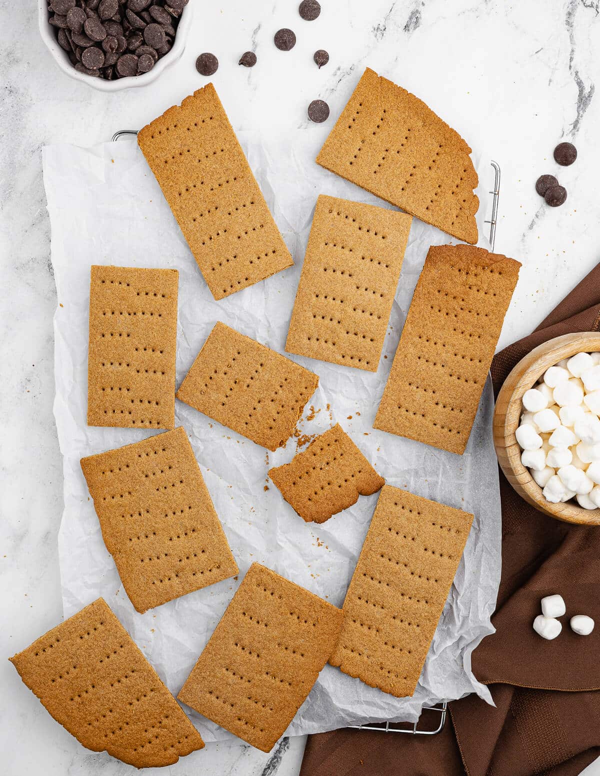 gluten-free graham crackers on a counter near chocolate chips and marshmallows