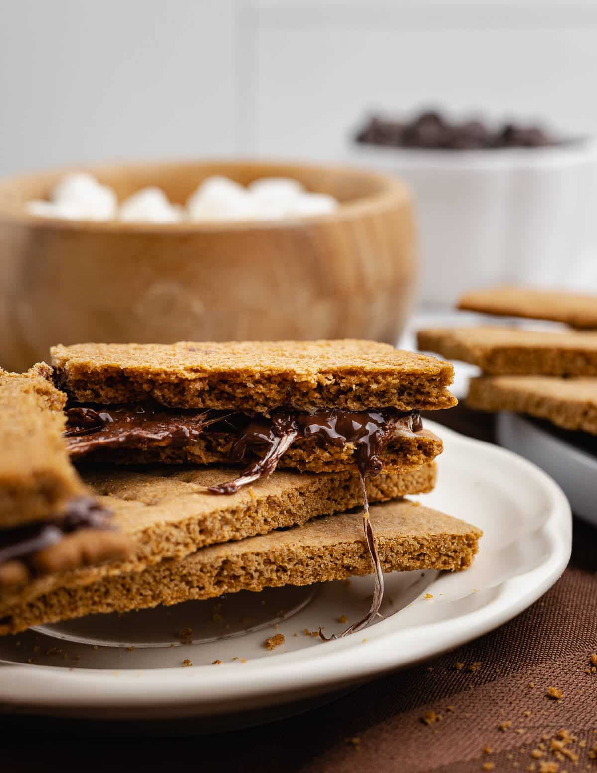 gluten-free graham crackers with melted chocolate inside on a plate.