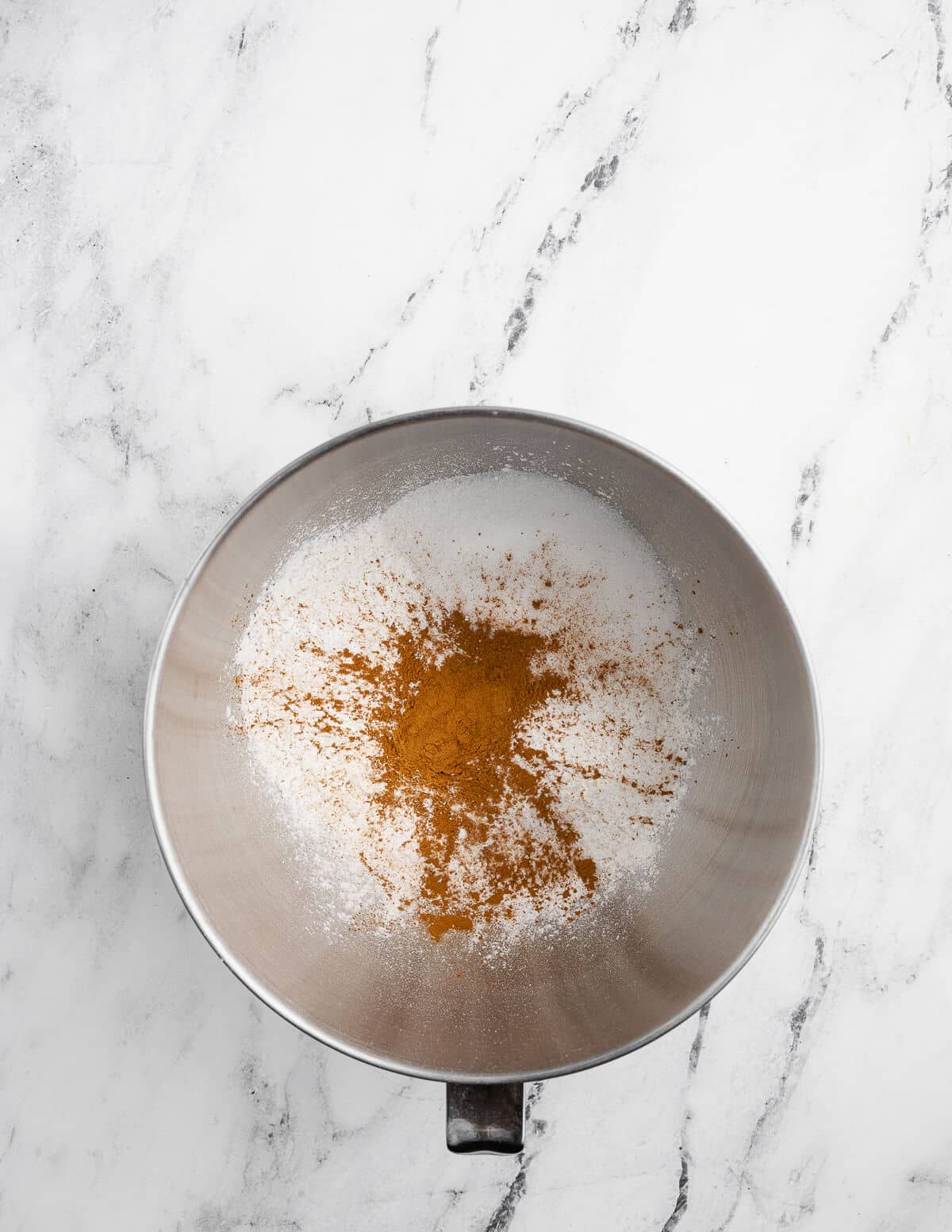 gluten-free flour, cinnamon, sugar, and baking powder in a mixing bowl.