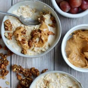 a bowl of oatmeal with peanut butter and granola on top.