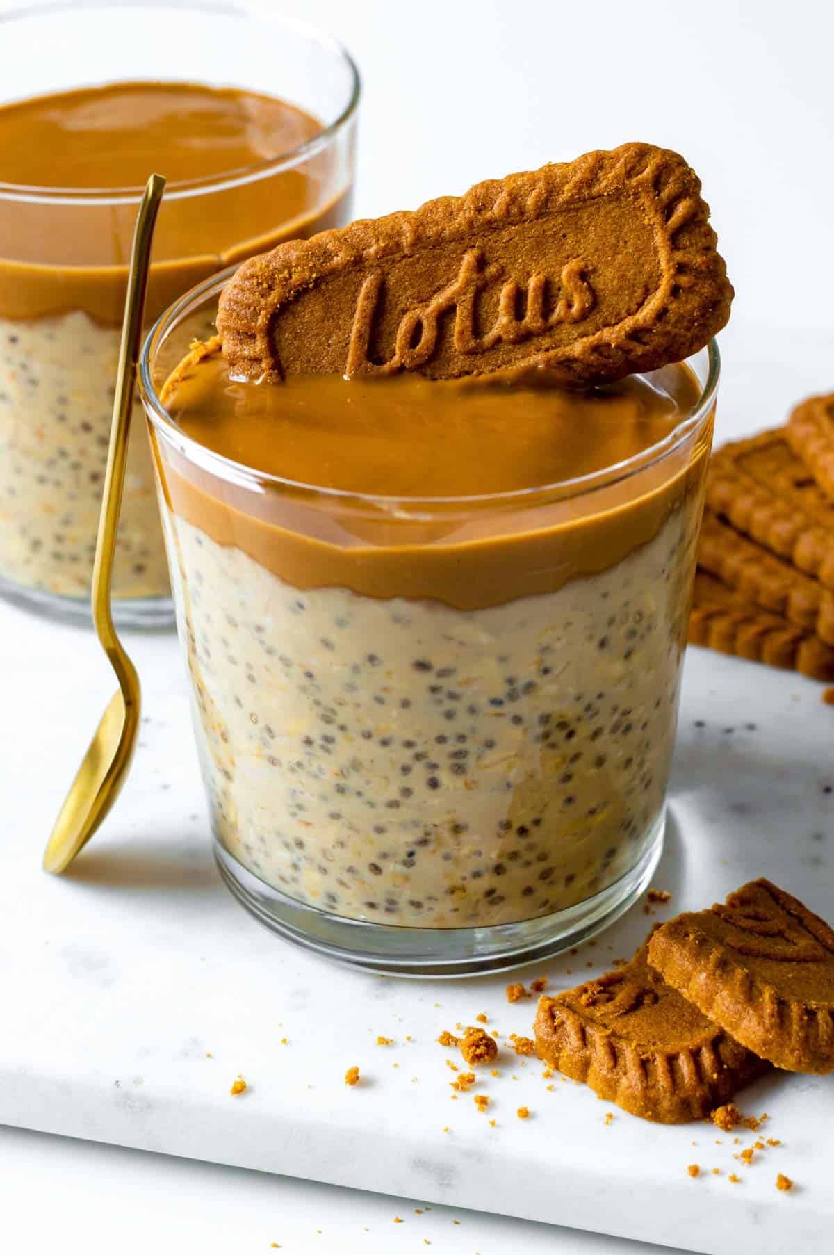 biscoff overnight oats in a glass with biscoff spread on top.
