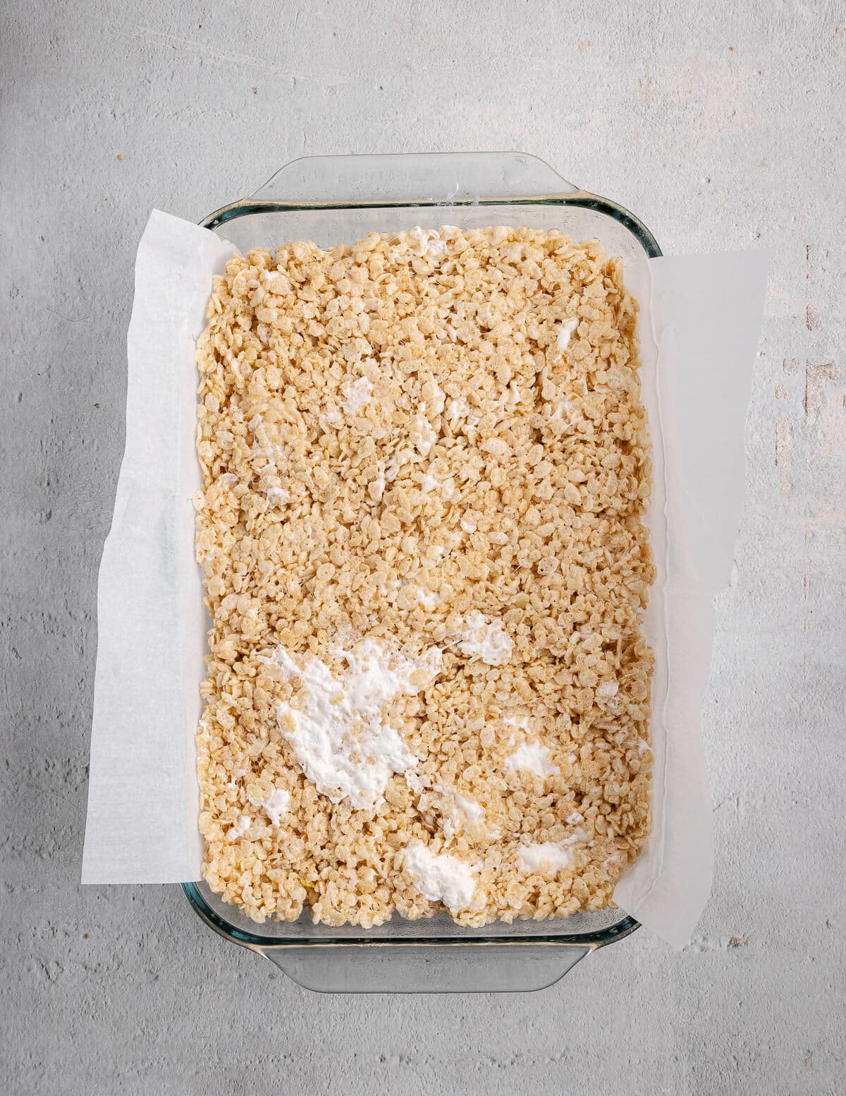 uncut homemade rice krispie bars in a baking dish.
