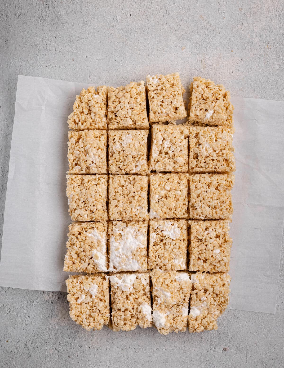 homemade cut rice krispie bars on parchment paper.