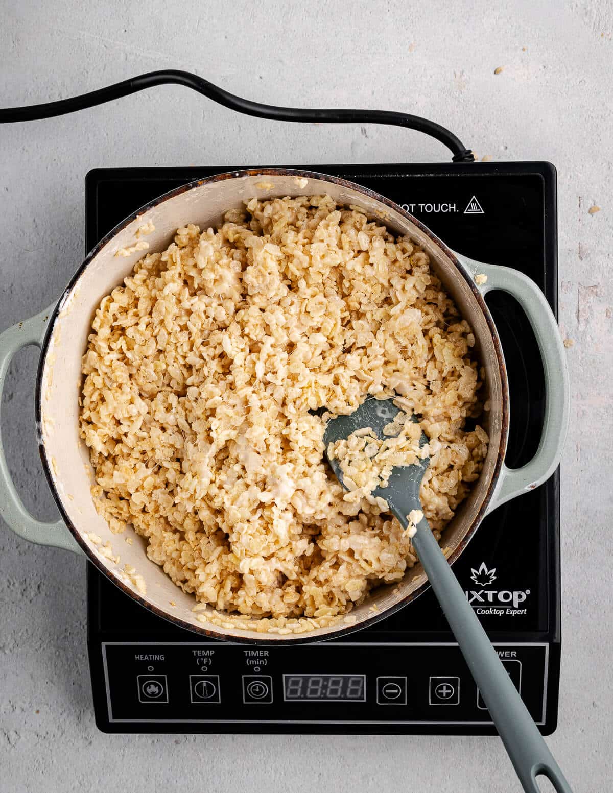 a dutch oven with sticky rice crispy mixture in it.