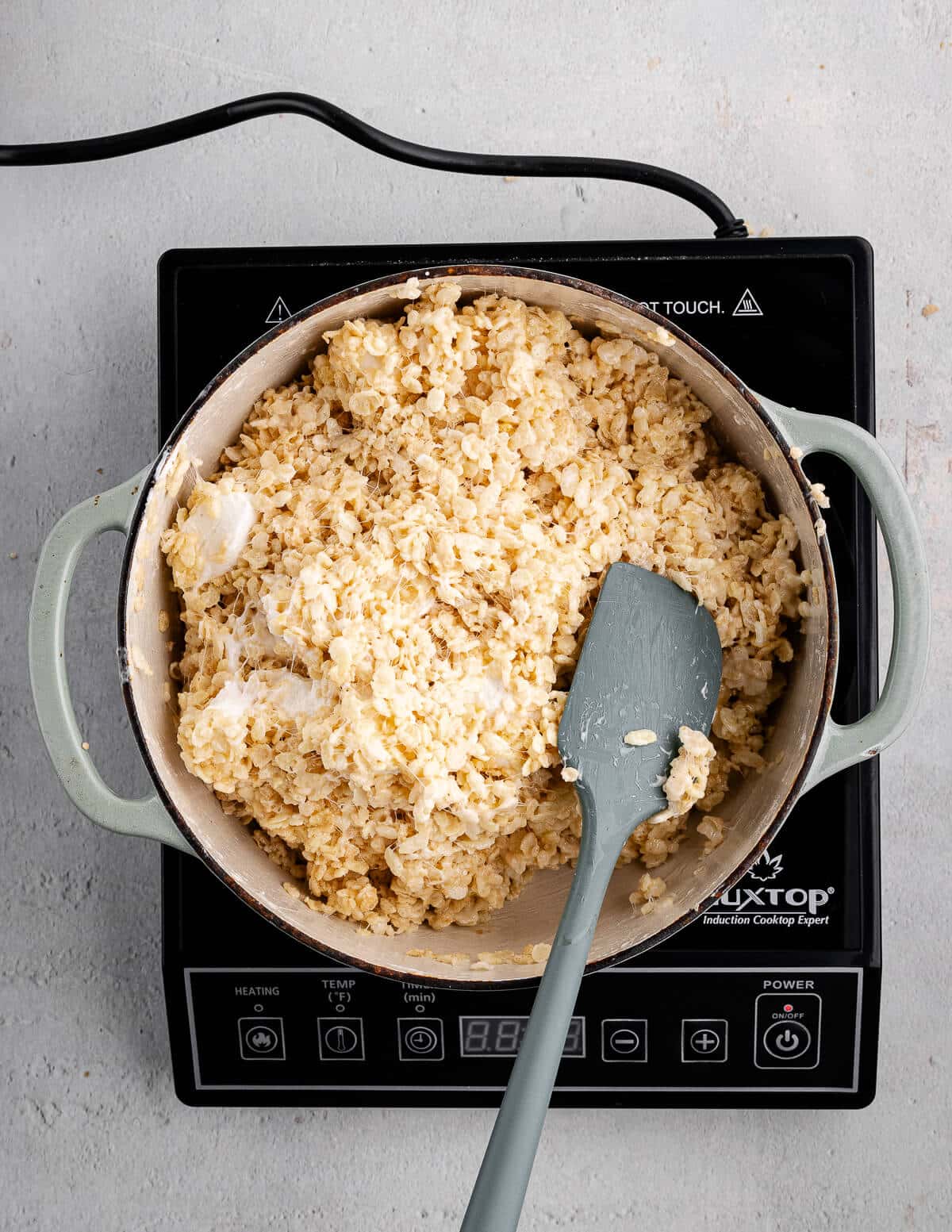 a dutch oven with sticky rice crispy mixture in it.