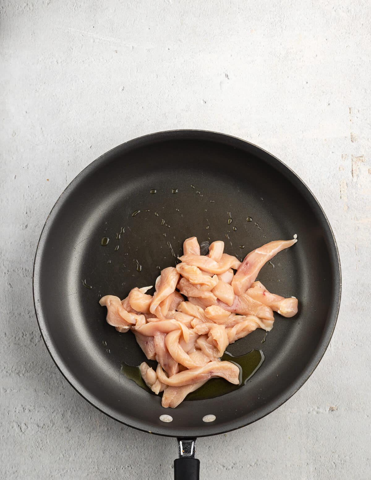 sliced chicken in a nonstick skillet.