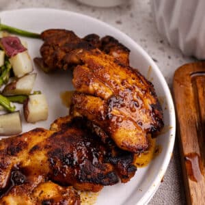 cooked boneless skinless chicken thighs on a plate.