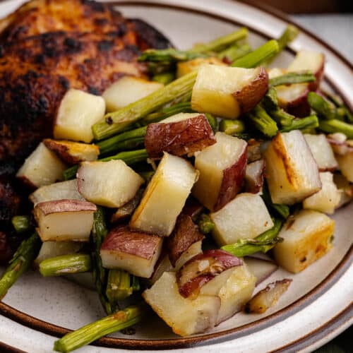 a plate of roasted potatoes and asparagus