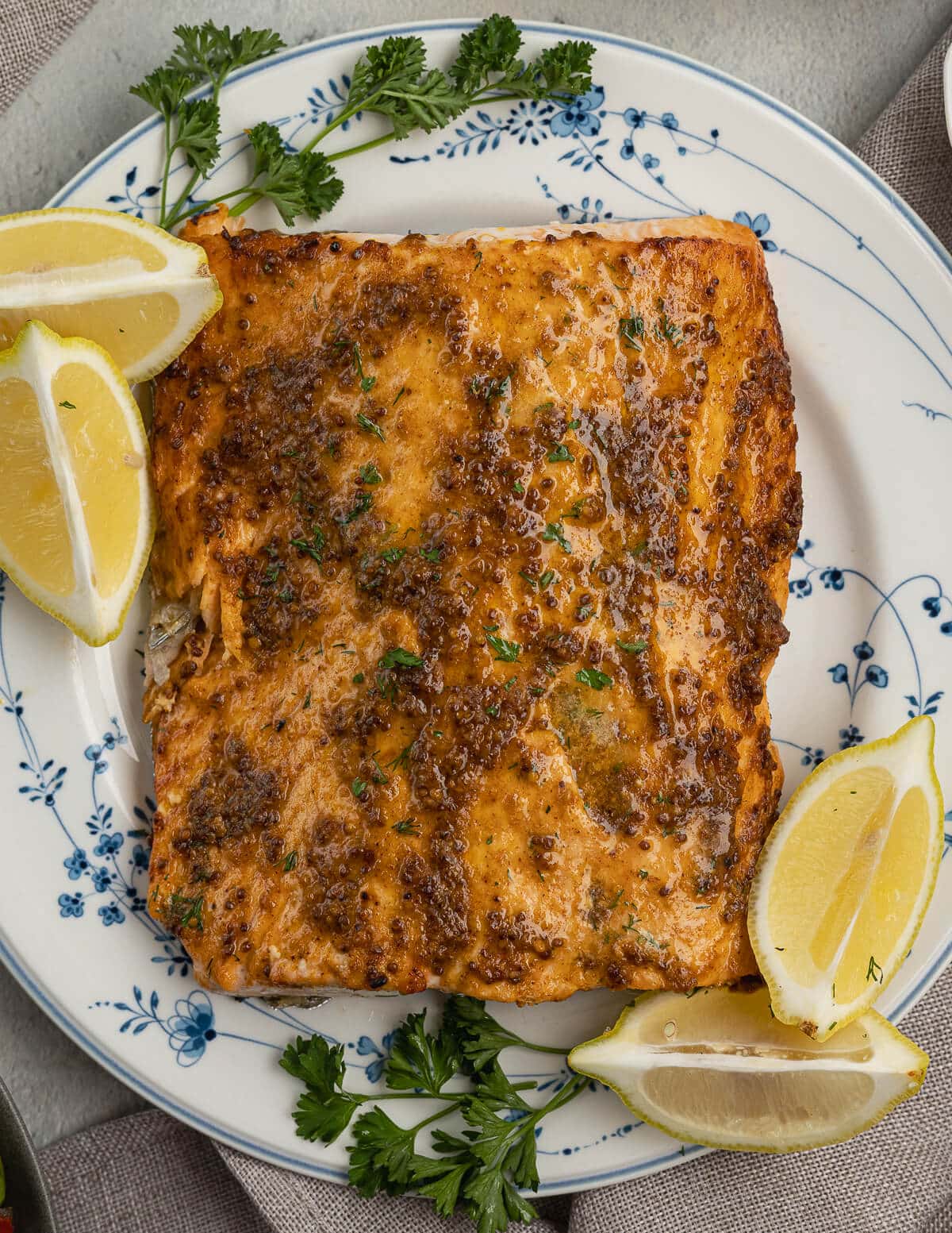 cooked salmon on a plate with lemons