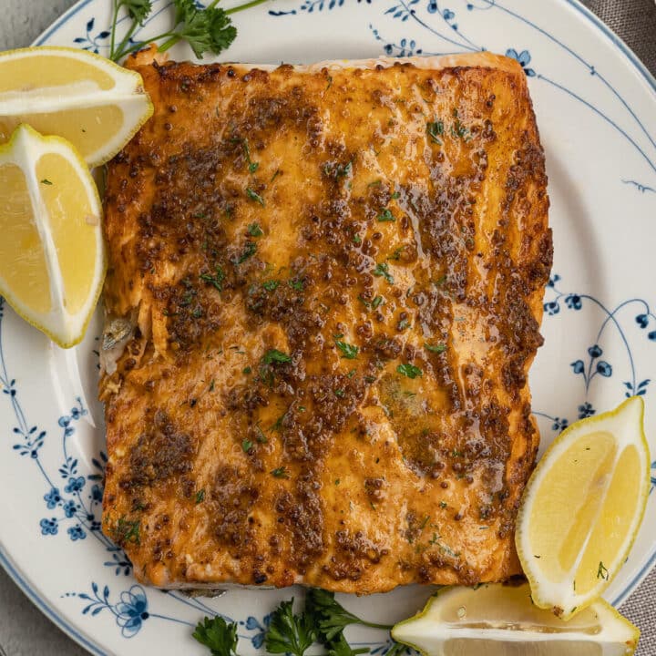 cooked salmon with lemons on aluminum foil.