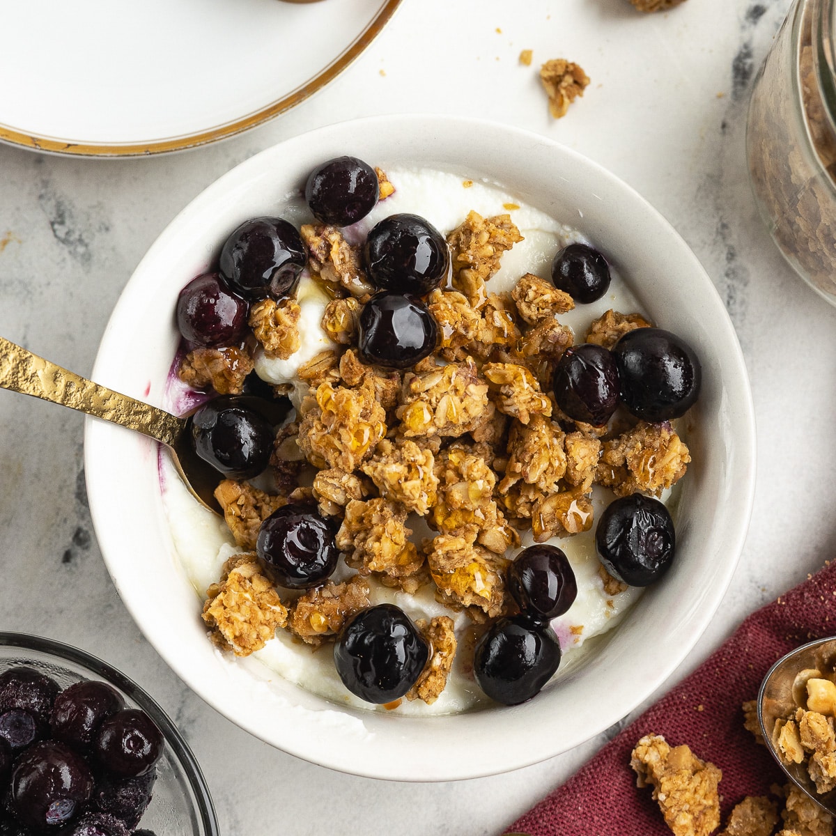 a bowl of peanut butter granola with blueberries