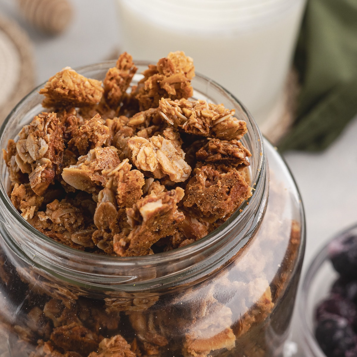 a jar with almond butter granola in it.