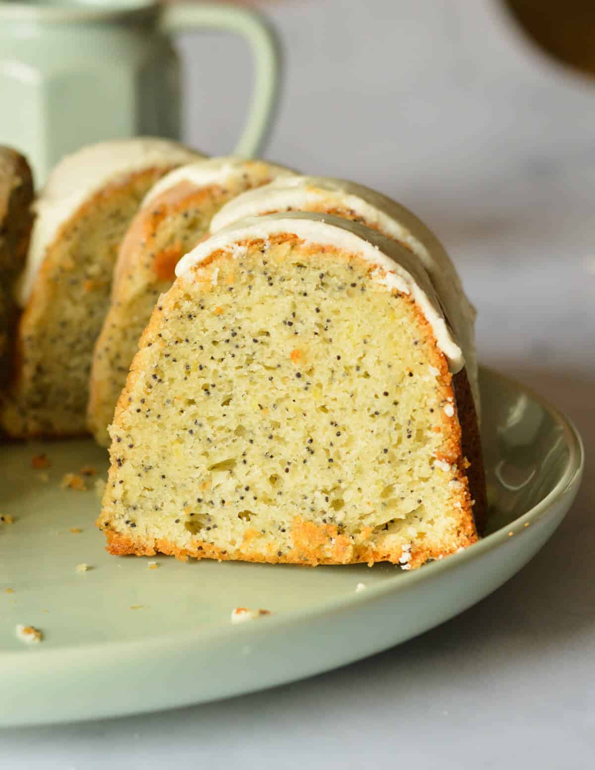 a slice of gluten free lemon poppyseed cake on a plate.