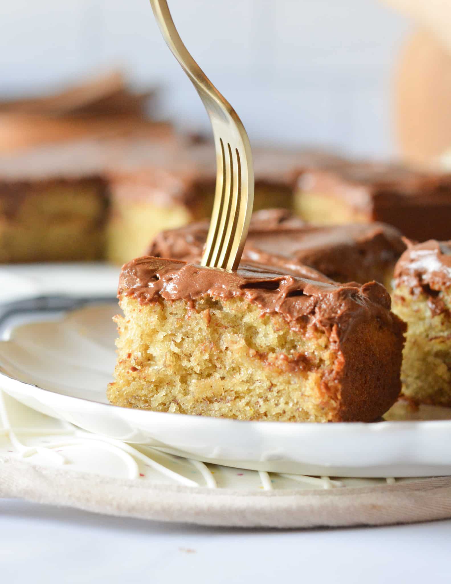 a slice of gluten free banana cake with a fork in it.