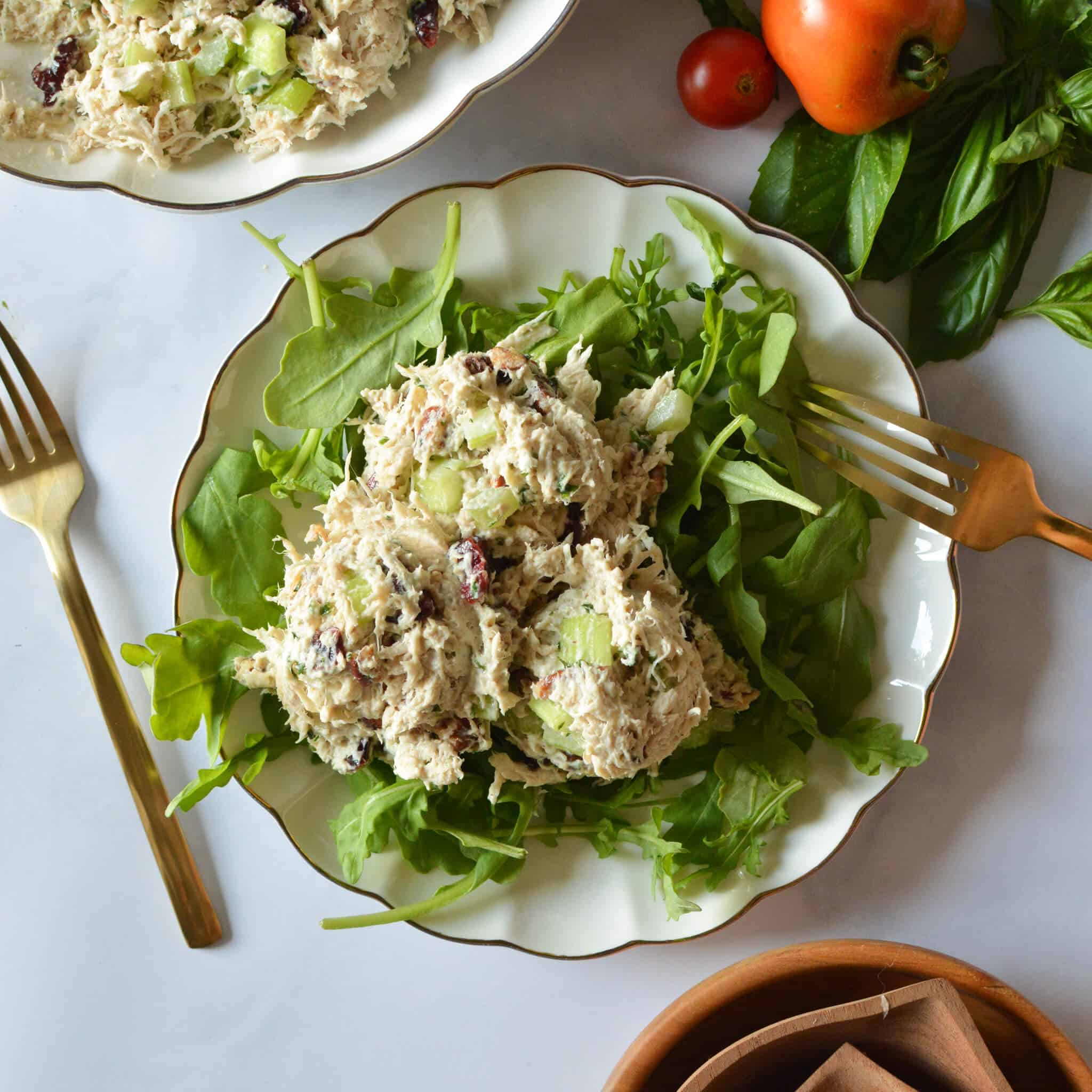 lemon basil chicken salad on a plate of arugula